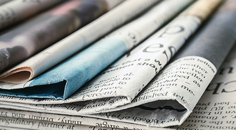 A stack of newspapers sitting on top of each other.